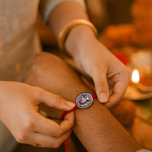 Round Ganesha Rakhi – Oxidized Silver Sunray Charm with Red Thread