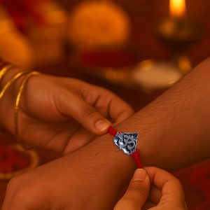 Om Leaf Rakhi for Brother – Spiritual Rakhi with Leaf-Shaped Metallic Om Pendant on Red Thread
