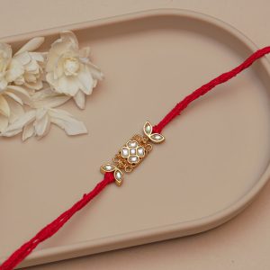 Designer Kundan Rakhi for Brother – Rectangular Golden Motif with Floral Ends on Red Thread