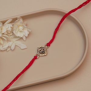 Om Rakhi for Brother – Antique Round Golden Om Symbol Rakhi with Red Cotton Thread